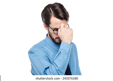 Depressed Man Holding Hand To Forehead