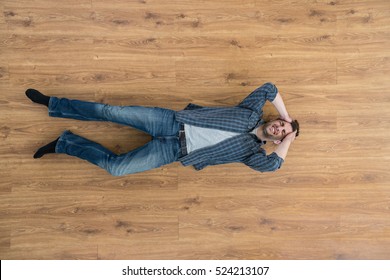 The depressed man lay on the floor and keep his head