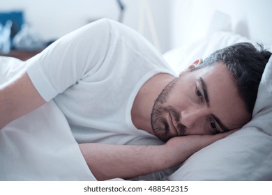 Depressed Man Lying In His Bed And Feeling Bad