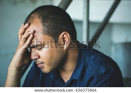 depressed man sitting head in hands.dramatic concept