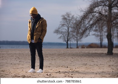 Depressed Man Standing Alone On Winter Beach