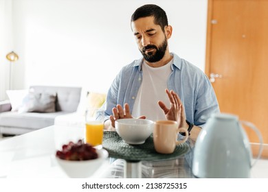 Depressed man at the table suffering from lack of appetite