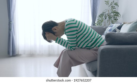 Depressed middle aged Asian woman. - Shutterstock ID 1927652207