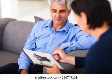 Depressed Middle Aged Man In Session With Therapist