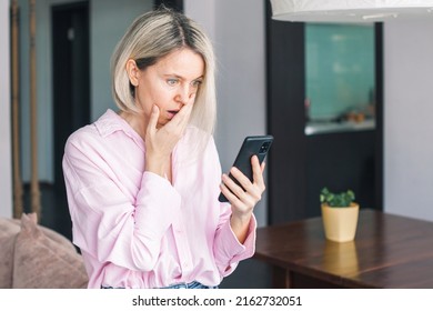 Depressed Middle-aged Woman Feel Upset And Sad After Phone Call, Bad News In Social Media Or Smart Phone Messenger Online App. Frustrated Beautiful Female Sit In Depression Alone On Sofa At Home