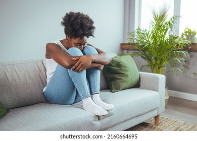 Depressed sad attractive woman crying on sofa couch at home feeling lonely tired and worried suffering depression in mental health, loneliness and isolation concept. Psychology, solitude and people - Powered by Shutterstock