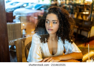 Depressed Sad Latin Woman In Bakery. Looking At The Horizon, Worried. End Of Relationship.