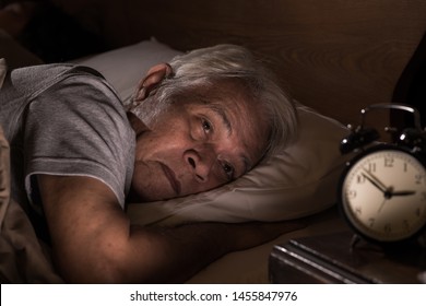 Depressed Senior Man Lying In Bed Cannot Sleep From Insomnia