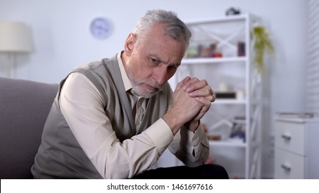 Depressed Senior Man Sitting On Coach And Thinking About Life Problems, Ptsd