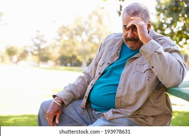 Depressed Senior Man Sitting Outside