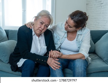 Depressed Senior Mother And Daughter Embracing Each Other Grieving Loss Of Loved Ones Amid Coronavirus Pandemic. Two Sad Women At Home In Lockdown In People And Families Affected By COVID-19 Outbreak.