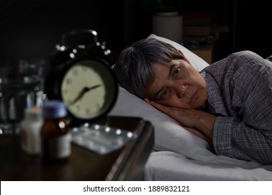 Depressed Senior Woman Lying In Bed Cannot Sleep From Insomnia