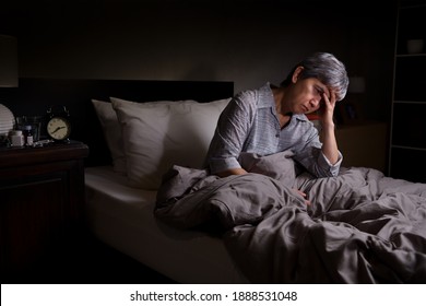 Depressed senior woman sitting in bed cannot sleep from insomnia - Shutterstock ID 1888531048