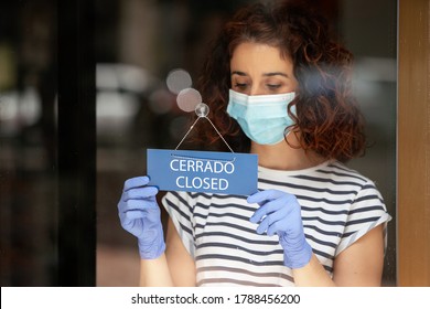 Depressed Shop Assistant Closing Her Retail Business To The Public During The Pandemic Quarantine Covid 19 In Spain. Financial Crisis And Coronavirus Concept.