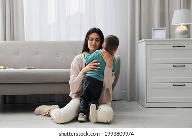 Depressed Single Mother With Child In Living Room