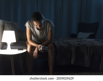 Depressed Sleepless Woman Staring At The Alarm Clock, She Can't Sleep And Suffers From Insomnia