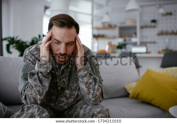 Depressed Soldier Sitting On Sofa Living Stock Photo 1734211010 ...