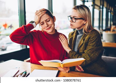 Depressed student crying because of difficulties in learning of studying material from textbook during private lesson with qualified female tutor.Teacher helps stressed hipster girl after fail in test