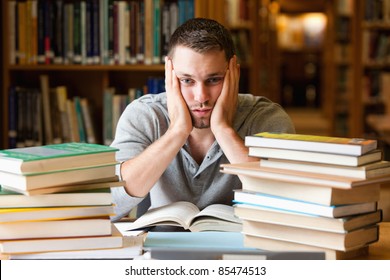 Depressed Student Having A Lot To Read Looking At The Camera