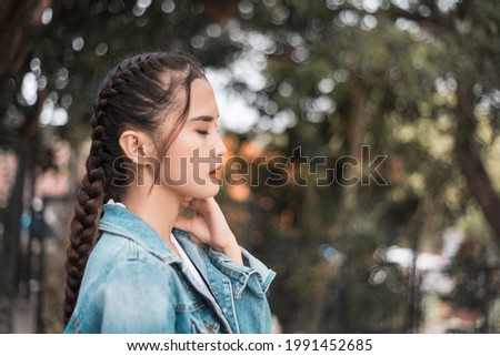 A depressed teenage asian girl after being heartbroken, bullied or ostracized.