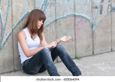 Depressed Teenage Girl Attempting Suicide By Cutting Her Wrist Veins With Knife.