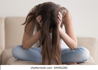 Depressed teenager sitting holding head in hands, stressed sad young woman having mental problems, feeling bad, need psychological help, addicted heartbroken girl experiencing adolescence crisis