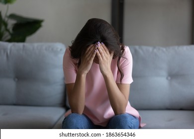 Depressed unhappy young arab mixed race woman feeling hopeless alone at home, suffering from psychological mental problems, relations breakup, betrayal or offend, abortion miscarriage concept.