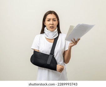 Depressed upset woman suffering from pain with bill payment No money to pay for medical care. Broken arm. woman put on plaster cast splint. Patient wearing sling support arm.