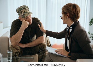 Depressed Veteran Listening To His Supportive Counselor During Therapy Session At Mental Health Center.