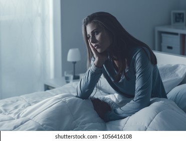 Depressed Woman Awake In The Night, She Is Exhausted And Suffering From Insomnia