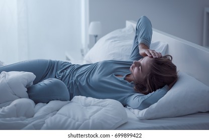 Depressed Woman Awake In The Night, She Is Exhausted And Suffering From Insomnia