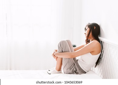 Depressed woman crying on her bed