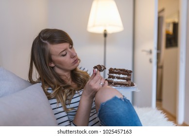 Depressed woman eats cake.  Sad unhappy woman eating cake. Sad woman eating sweet cake. Close up of woman eating chocolate cake. food, junk-food, culinary, baking and holidays concept 