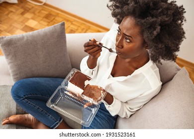 Depressed woman eats cake. Sad unhappy woman eating cake. Sad woman eating sweet cake. Close up of woman eating chocolate cake. Food, junk-food, culinary, baking and holidays concept
