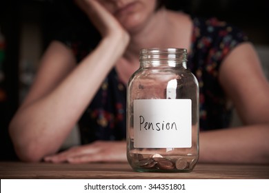 Depressed Woman Looking At Empty Jar Labelled Pension