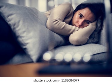 Depressed Woman Lying On The Bed