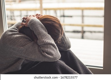 Depressed woman must stay in home quarantine due to corona virus covid-19. - Shutterstock ID 1678215577