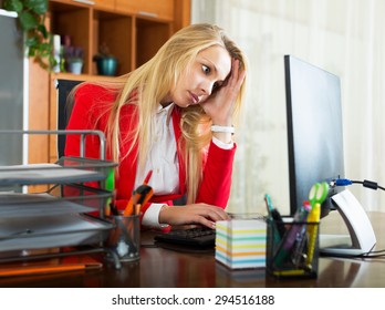 Depressed Woman In Red Jacket Working On Pc