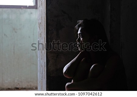 Depressed woman sitting on ground, female in depression sadness in dark tone