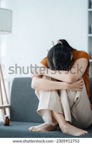 Depressed woman suffering from headaches, fighting stress with antidepressants, close-up view.