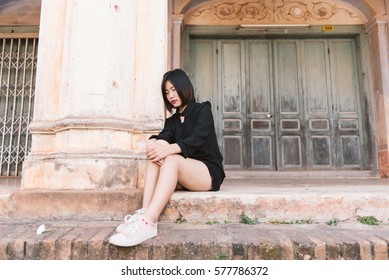 Depressed women. Young hipster woman in black dress sad.  Vintage filter toned. - Shutterstock ID 577786372