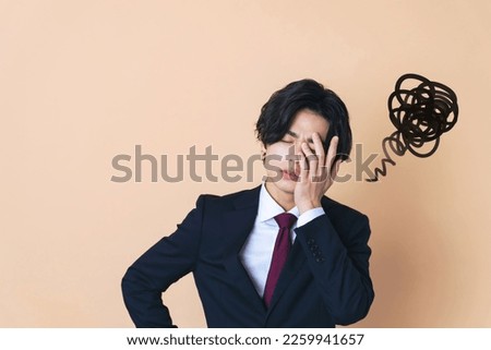 Depressed young Asian businessman. Facial expression.