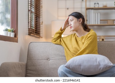 Depressed young Asian woman sitting on floor at home, Frustrated confused Sad female feels unhappy problem in personal life quarrel breakup with boyfriend or unexpected pregnancy concept