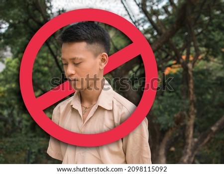 A depressed young man after being bashed, blocked or shunned in social media or in person. Cancel culture concept. With stop sign graphic. Stock photo © 
