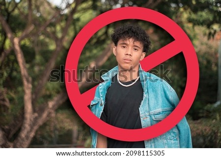 A depressed young man after being called out, shunned or blocked in social media or in person. Cancel culture concept. With stop sign graphic. Stock photo © 