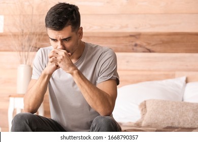 Depressed Young Man In Bedroom