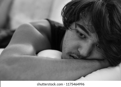  Depressed young man lying in bed. Sadness and unhappy.