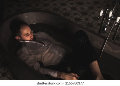 Depressed Young Man Mental Health In Bathtub In Bathroom At Home. Crazy Person Showing Human Emotions. Concept Apathy, Anxiety, Illness, Trouble, Creative Decline. Copy Space