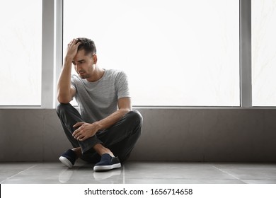 Depressed Young Man Near Window