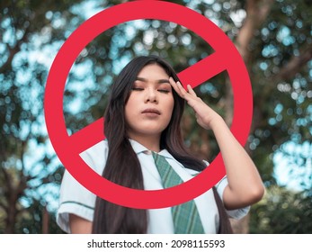 A depressed young woman after being called out, blocked, or shunned in social media or in person. Cancel culture concept. With stop sign graphic. - Shutterstock ID 2098115593